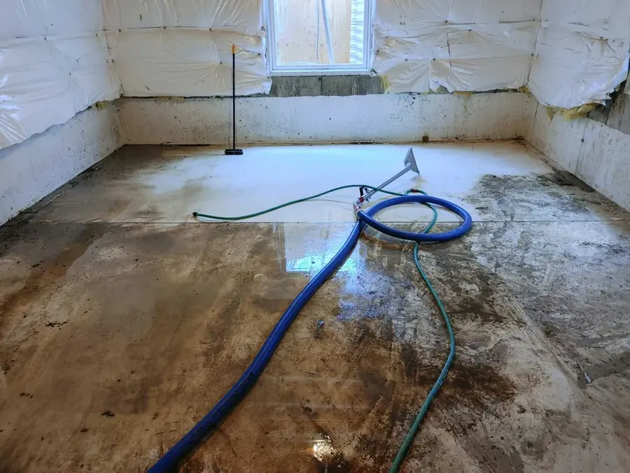 Restoration technician extracting standing water from a flooded Colorado Springs home