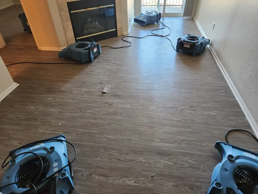 Air movers and a dehumidifier drying a water damaged Colorado Springs basement