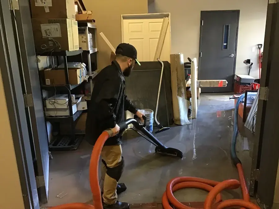 Technician extracting standing water from a Colorado Springs floor